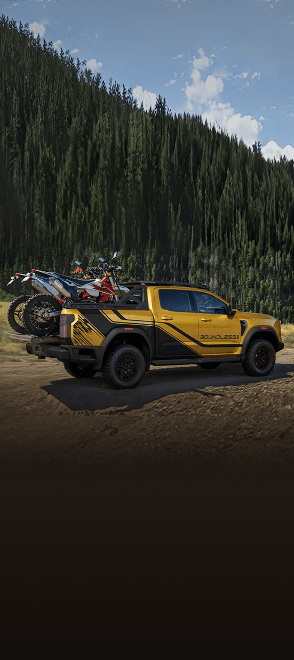 Yellow pickup truck carrying two dirt bikes on a dirt road by a forest.